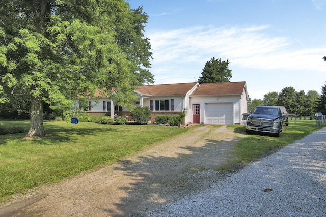 view of front of home with a front lawn, an attached garage, and dirt driveway