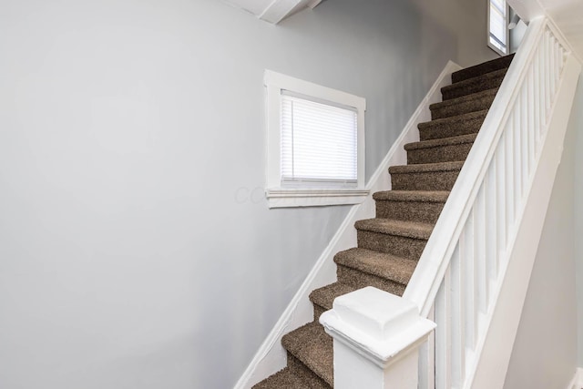 stairs featuring baseboards