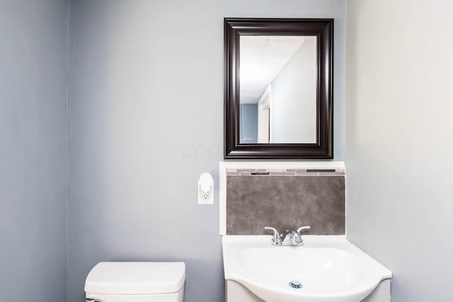 bathroom with toilet and vanity