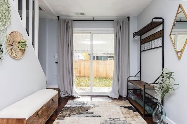 entryway featuring dark wood-style flooring, baseboards, and visible vents