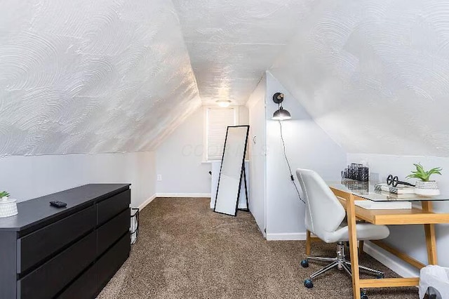 home office featuring baseboards, vaulted ceiling, dark colored carpet, and a textured ceiling