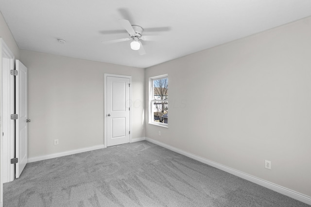 unfurnished bedroom featuring baseboards, carpet floors, and a ceiling fan