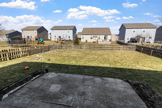 view of yard featuring a patio area, a residential view, a playground, and a trampoline