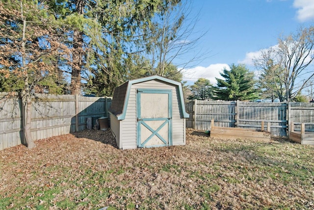 view of shed featuring a vegetable garden and a fenced backyard