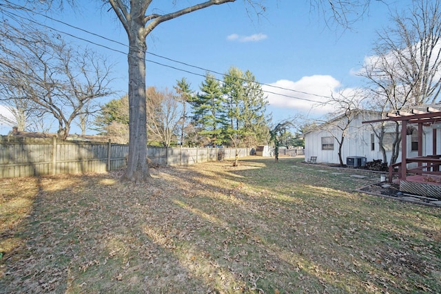 view of yard featuring central AC and fence private yard