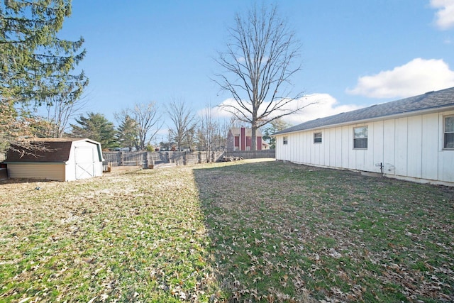 view of yard with a fenced backyard, a storage shed, and an outdoor structure