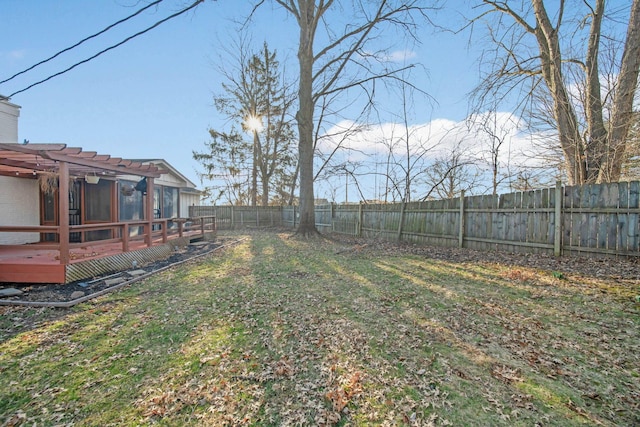 view of yard featuring a deck, a pergola, and a fenced backyard