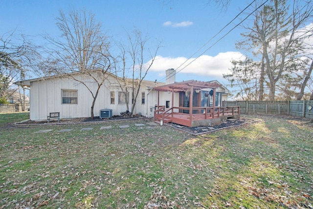 back of house with a pergola, a fenced backyard, cooling unit, a yard, and a chimney