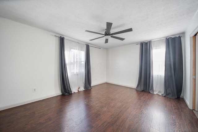 unfurnished room with a textured ceiling, wood finished floors, baseboards, and ceiling fan