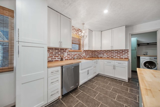 kitchen featuring dishwasher, washer / clothes dryer, white cabinetry, and butcher block counters