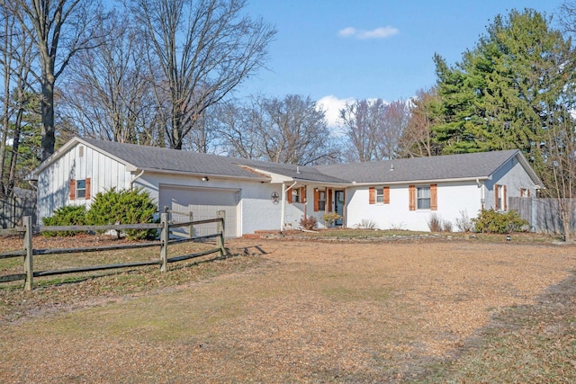 single story home featuring a garage and fence