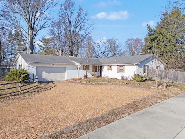 ranch-style house with driveway, an attached garage, and fence