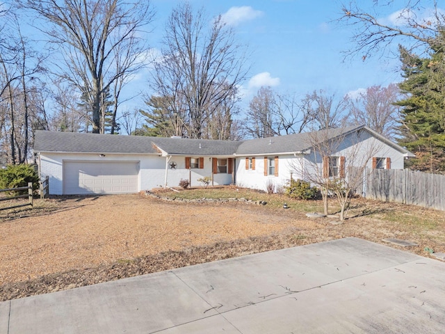 ranch-style home with driveway, a garage, and fence