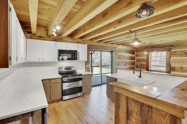 kitchen featuring light wood-style flooring, a sink, tasteful backsplash, black microwave, and range with two ovens