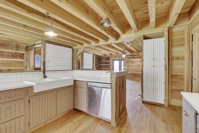 kitchen featuring a sink, beamed ceiling, light wood-style floors, and stainless steel dishwasher