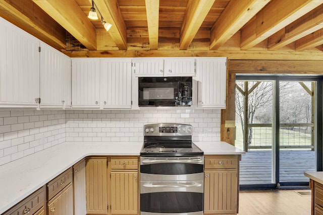 kitchen featuring range with two ovens, black microwave, and light countertops