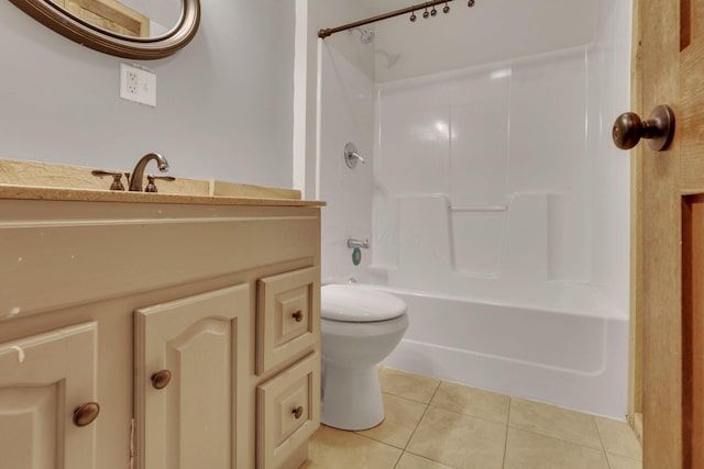 bathroom featuring vanity, tile patterned floors, toilet, and bathing tub / shower combination