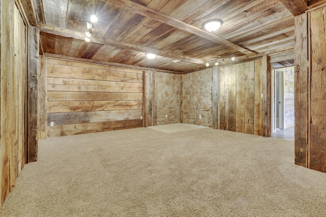 empty room with wood walls, wooden ceiling, and carpet floors