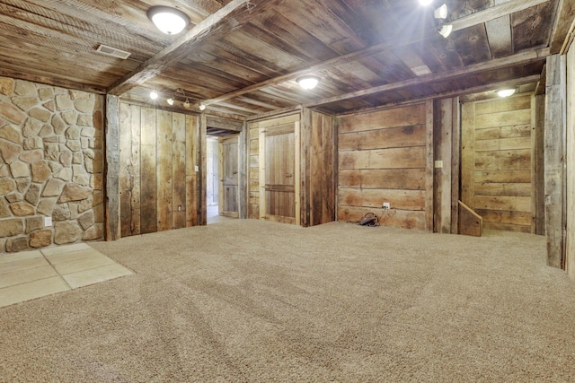 finished basement with wooden walls, wood ceiling, visible vents, and carpet floors