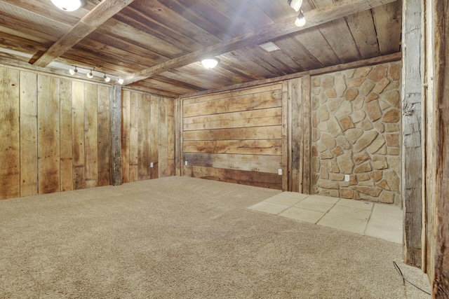 interior space with beamed ceiling, wood walls, and wooden ceiling