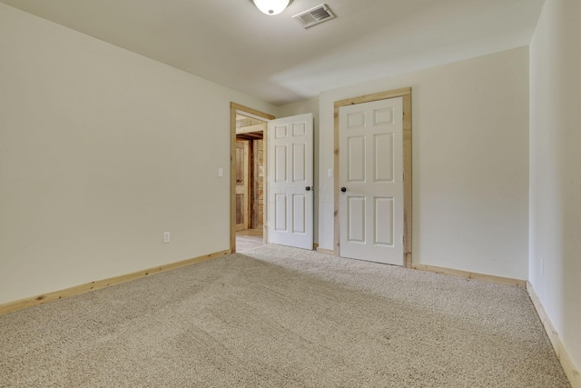 unfurnished bedroom with baseboards, visible vents, and carpet floors