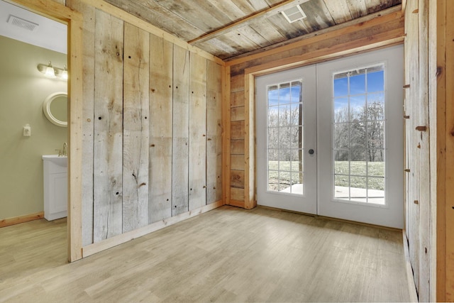 unfurnished room featuring wood finished floors, wood ceiling, french doors, and visible vents