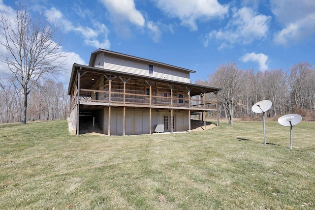 rear view of property with a wooden deck and a yard