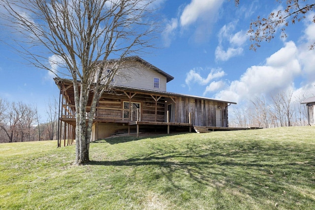 back of property featuring a lawn