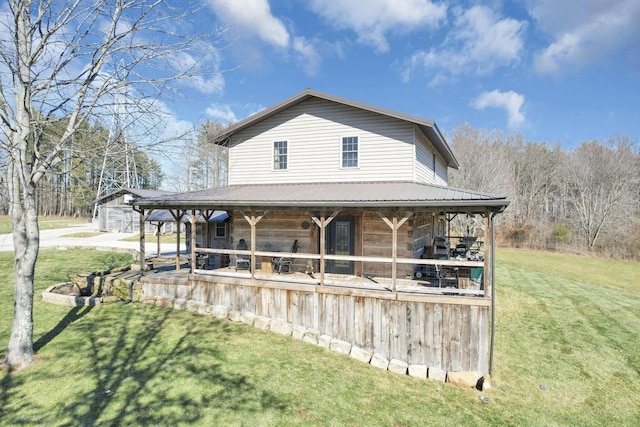 view of front facade featuring metal roof and an outbuilding