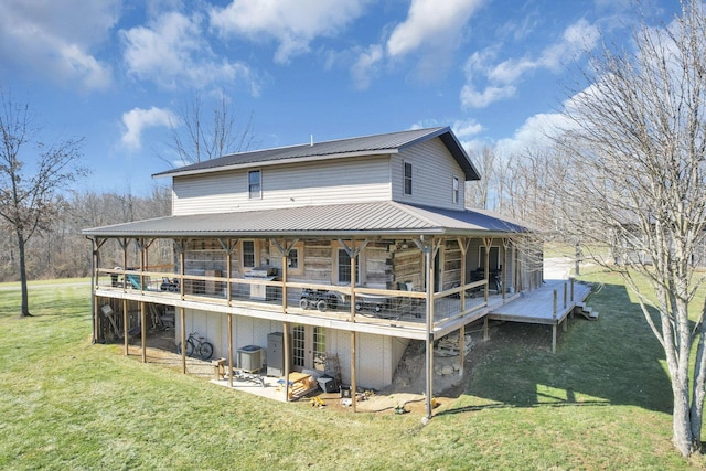 back of house with a wooden deck, a yard, central AC, stone siding, and metal roof