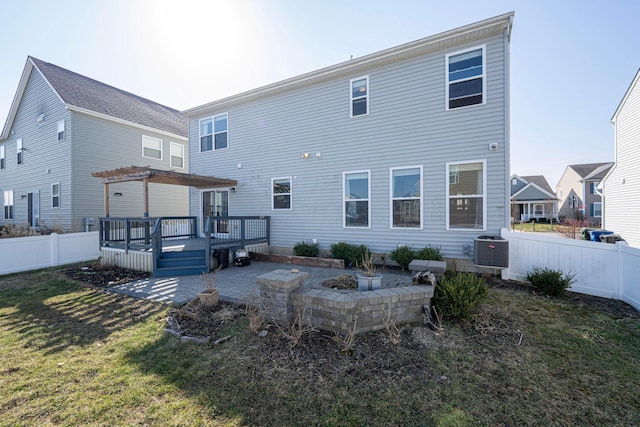 rear view of house with a lawn, a fenced backyard, a deck, a patio area, and a pergola