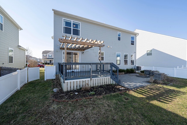 back of house with a lawn, a deck, a pergola, a fenced backyard, and central AC unit