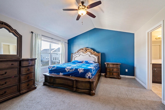 carpeted bedroom featuring vaulted ceiling, a ceiling fan, baseboards, and a textured ceiling