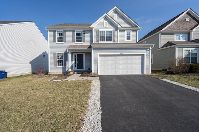 view of front of house with aphalt driveway, a front lawn, and a garage