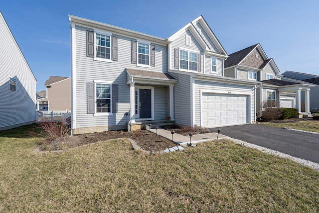 view of front of house featuring aphalt driveway, an attached garage, a front yard, and fence