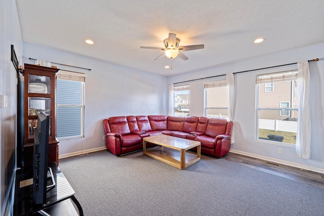 living room with recessed lighting, a ceiling fan, baseboards, and a textured ceiling