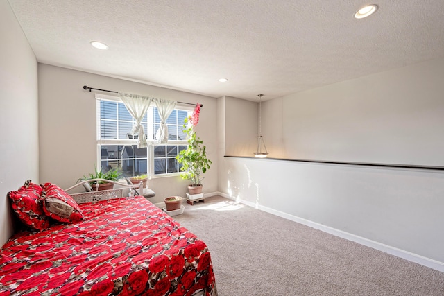 bedroom featuring recessed lighting, baseboards, carpet, and a textured ceiling