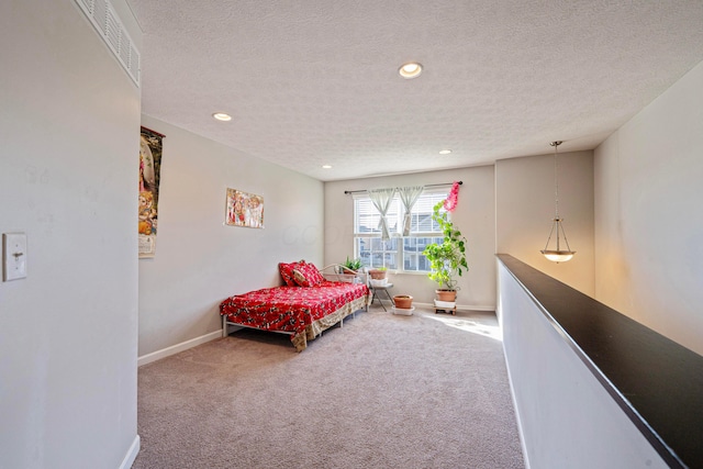 bedroom with baseboards, a textured ceiling, and carpet flooring