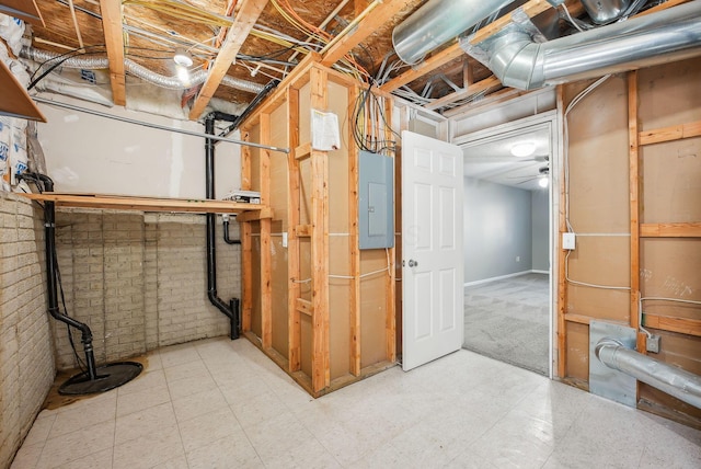 unfinished basement with electric panel and brick wall