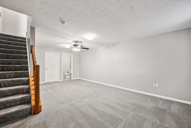 interior space with a ceiling fan, a textured ceiling, stairway, carpet flooring, and baseboards