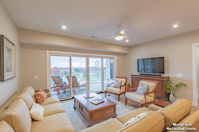 living area with recessed lighting, visible vents, and ceiling fan