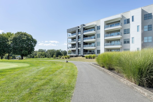 view of property's community with a lawn