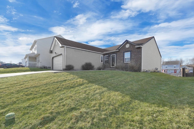 view of front of house featuring an attached garage, concrete driveway, and a front lawn