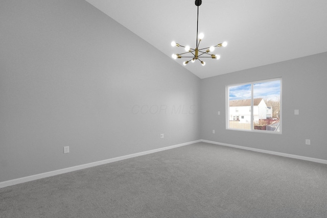 carpeted spare room featuring a notable chandelier, baseboards, and high vaulted ceiling