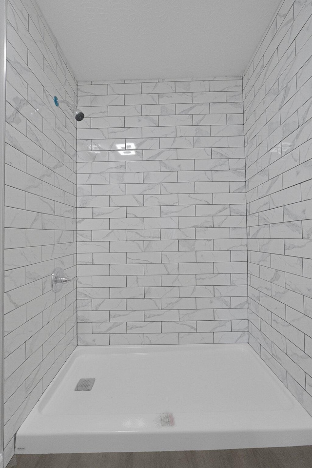 bathroom with tiled shower