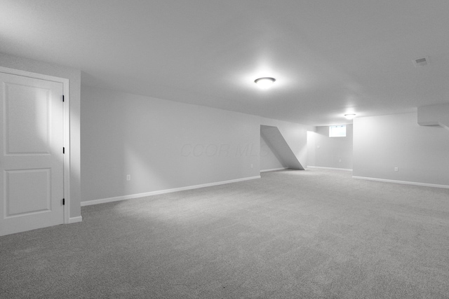 finished basement featuring visible vents, carpet, and baseboards