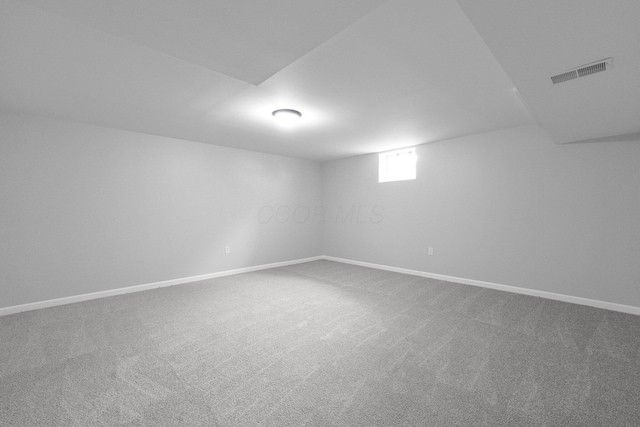 below grade area with carpet flooring, baseboards, and visible vents