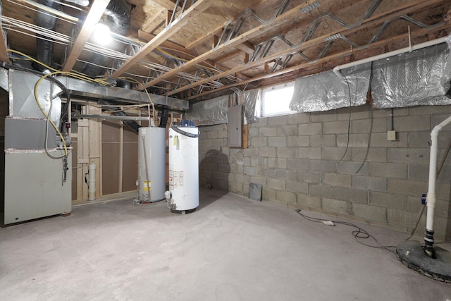 basement featuring gas water heater, heating unit, and electric panel