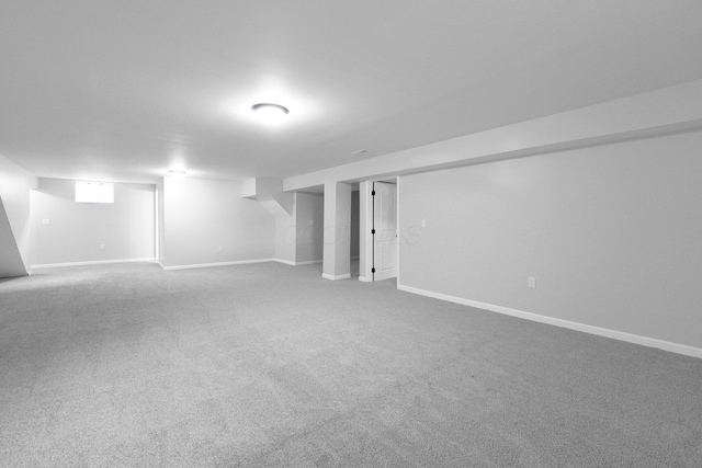 finished basement featuring carpet flooring and baseboards