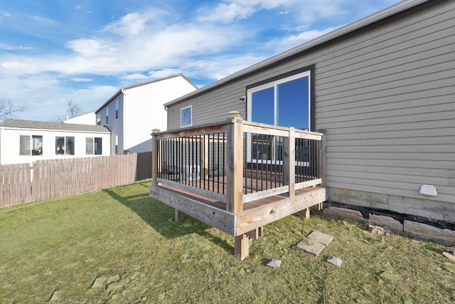 wooden terrace with a yard and fence